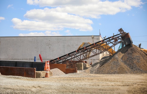 A large pile of gravel is being used to make a pile of gravel.