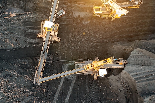 Large piles of coal top view Coal storage at the TPP unloading and loading of coal by excavators and transport belts at the TPP warehouse Aerial photography