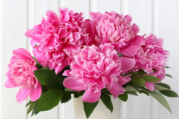 Large pink peony flowers as a background bouquet close-up