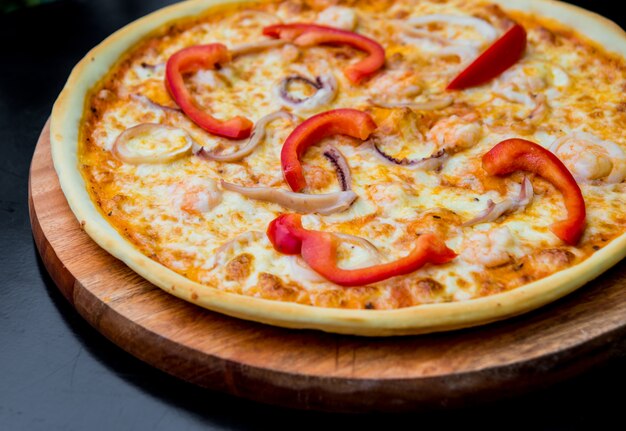 Large pizza on a wooden table. Restaurant.