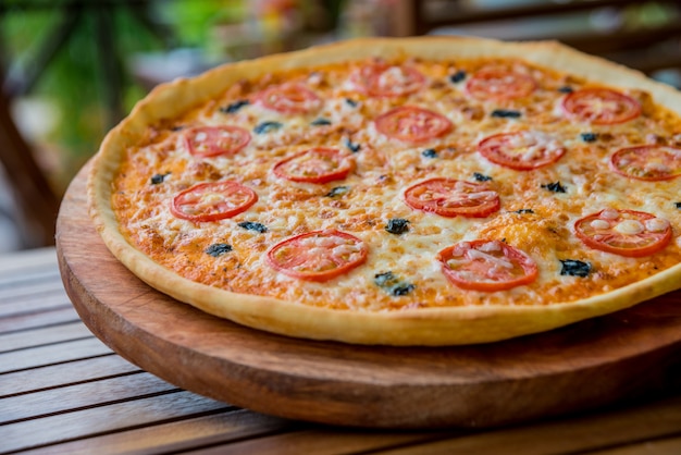 Large pizza on a wooden table Restaurant