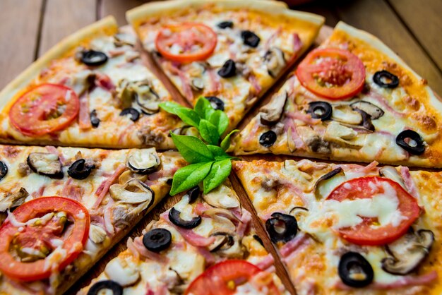 Large pizza on a wooden table.