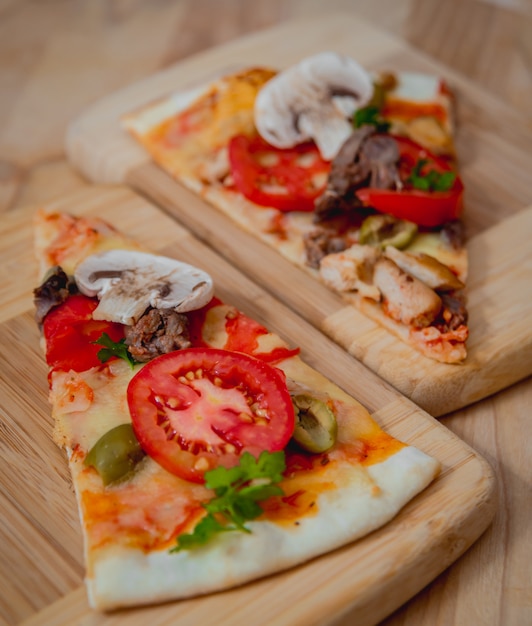 Large pizza on a wooden table.