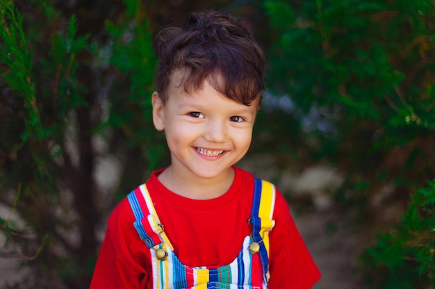 A large portrait of a cute funny boy with a slugged tongue the child shows a speech therapy exercise...