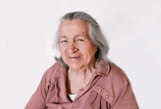 Large portrait of an old woman on an isolated white background, elderly people pensioners