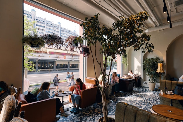 Large potted tangerine tree in hallway of modern restaurant