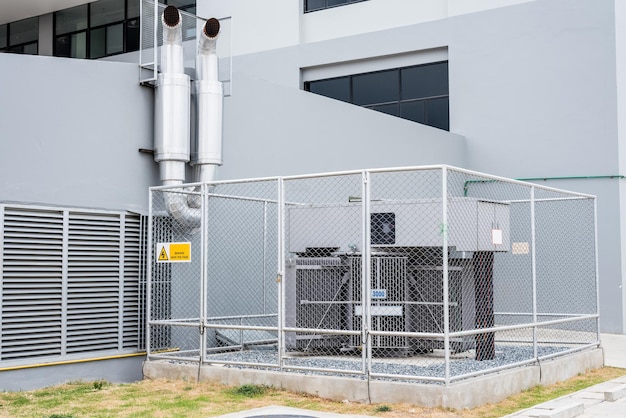 Large power transformers are installed outside the building