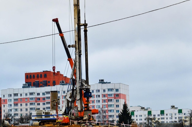 A large powerful iron pile driver an industrial construction machine designed for lifting installing