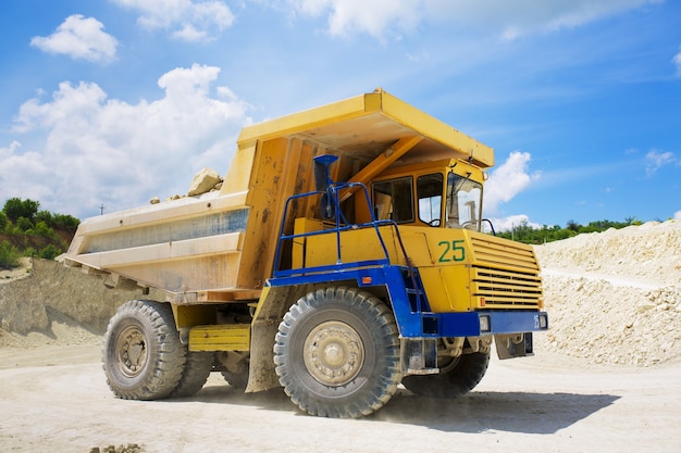 A large quarry dump truck loaded with rock