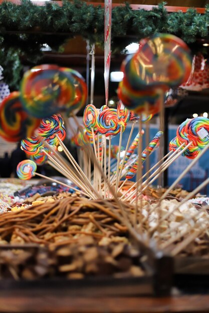 The Large Rainbow Swirl Lollipop. Sweet candies in Christmas market. Selective focus.