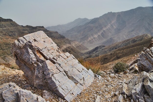 Large rectangular boulder with view of desert mountains