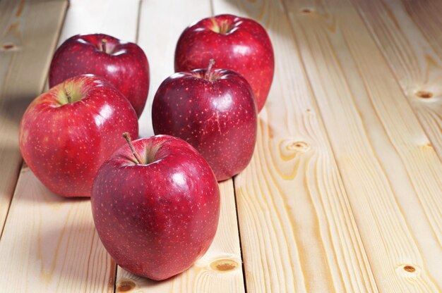 Large red apples on a wooden table