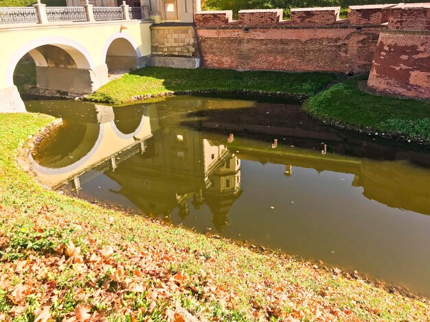 A large red brick earthen wall is strong protective and a moat with the war of an old ancient