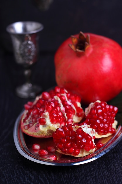 Large red pomegranate on a black background