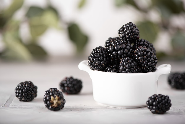 Large ripe blackberry in a white bowl