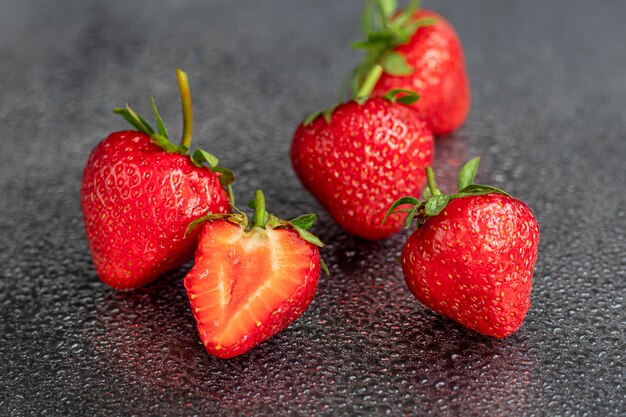 Large ripe strawberries are collected from the garden