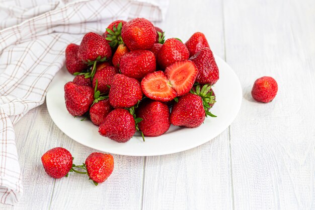 Large ripe strawberries are collected from the garden