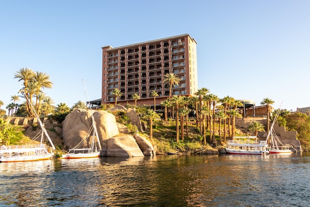 A large rock formation is visible behind the water and the building is a disney resort.