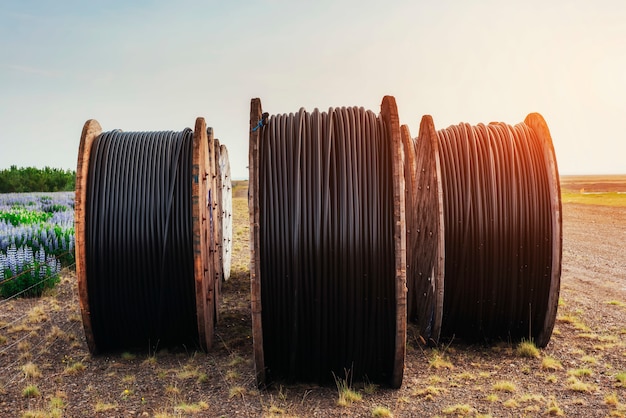 Large rolls of wires against the blue sky at sunset.