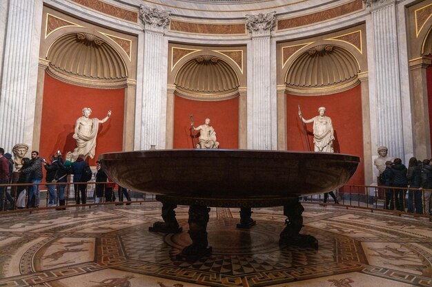 A large round table with statues of people on it