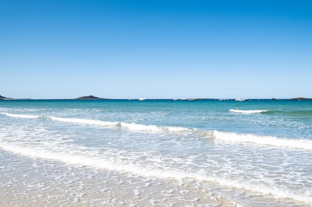 Large sandy beach in the town of Sables d'or les pins in Brittany at low tide in summer