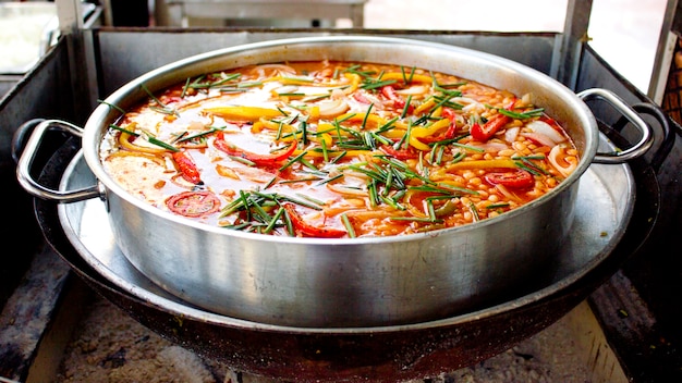 Large saucepan of stewed vegetables on fire