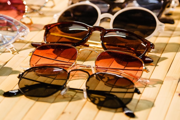 Large selection of sunglasses and glasses on a stand