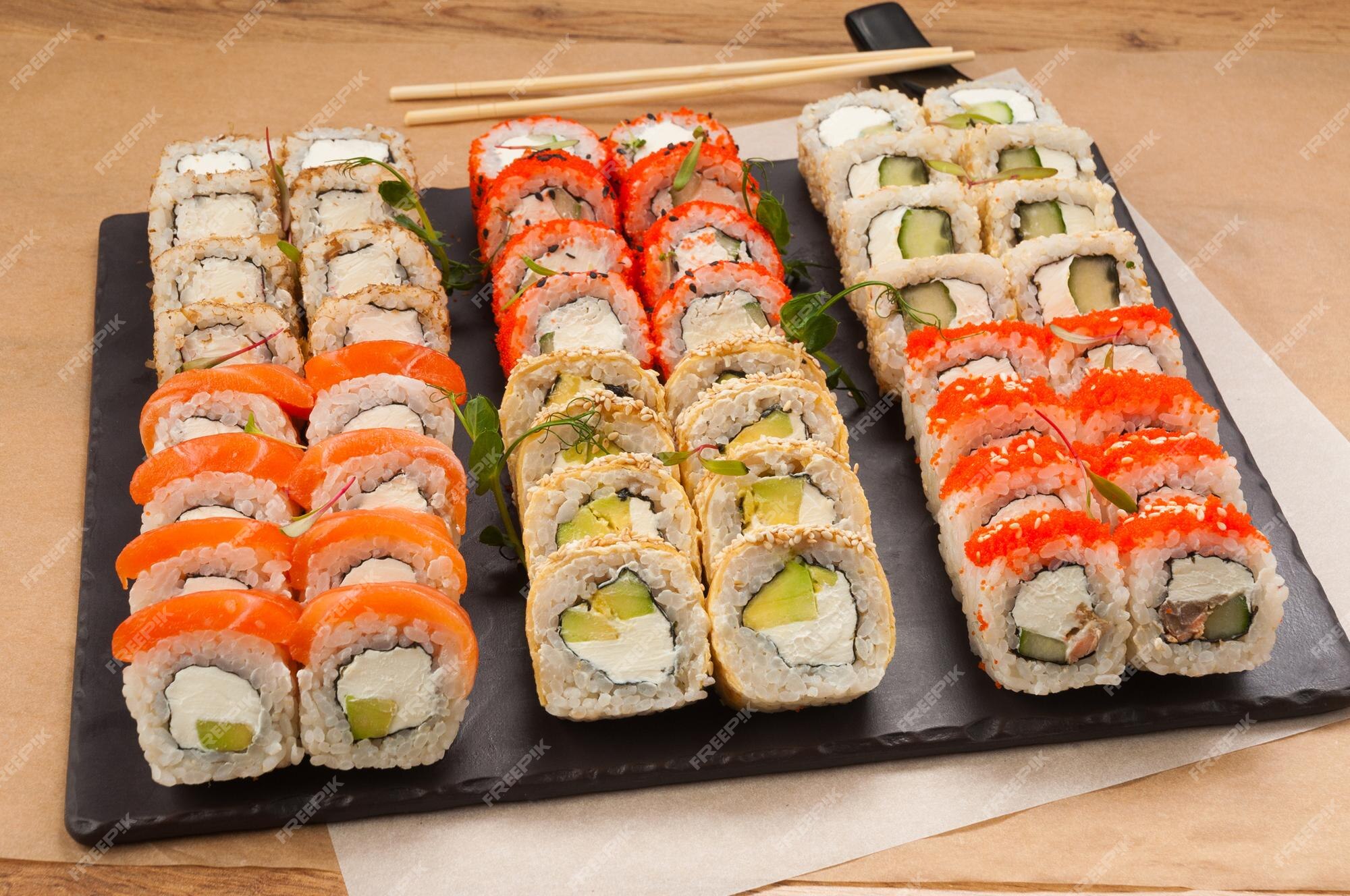 Japanese Sushi Set. Sashimi, Maki Rolls. On Plate Over Stone