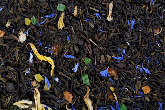 A large sheet of green tea, cornflower petals, sunflower petals, colorful candied fruit.