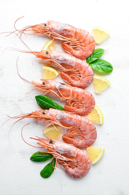 Large shrimp with lemon Top view Free space for your text On the old background