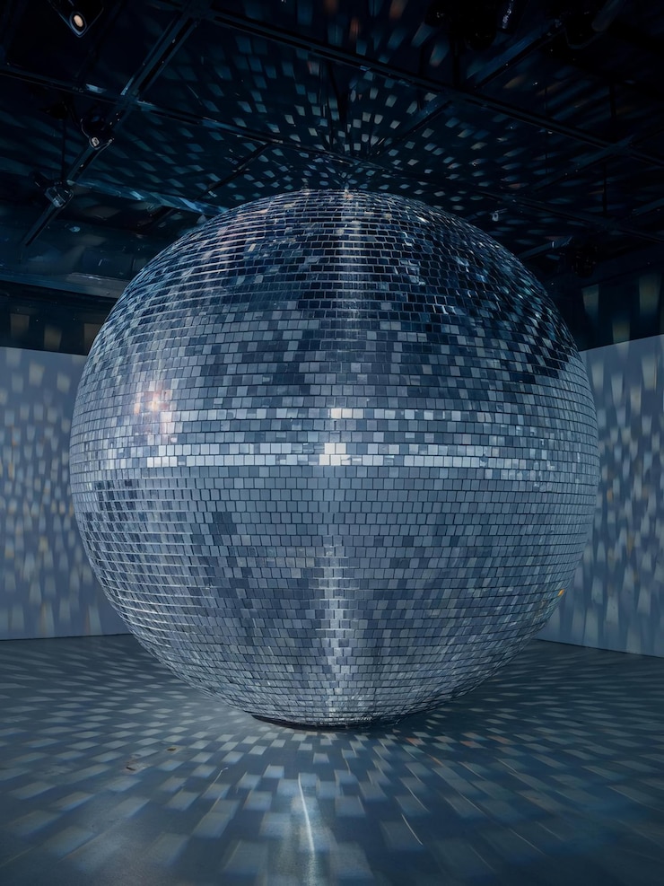 a large silver ball with many small dots on the bottom