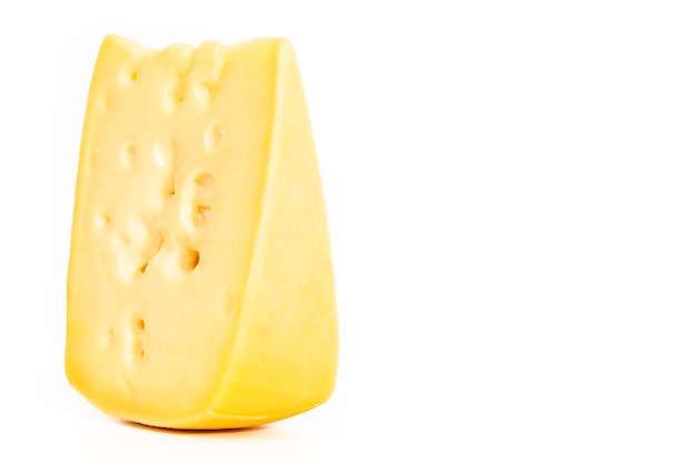 Large slice of semi soft part skim cheese on a white background.