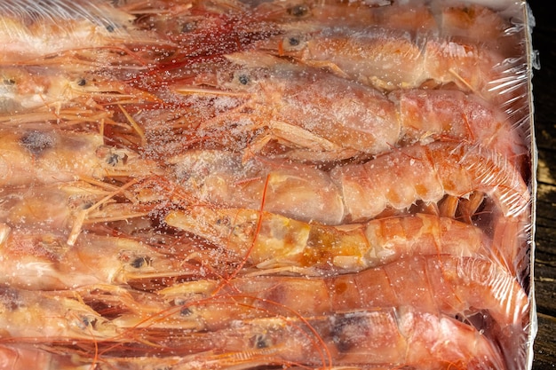 large and small frozen shrimp with or without heads, pink, with tentacles, mustache and legs