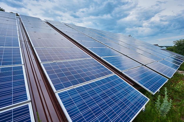 Large solar energy system ground mounted solar panel against\
blue sky