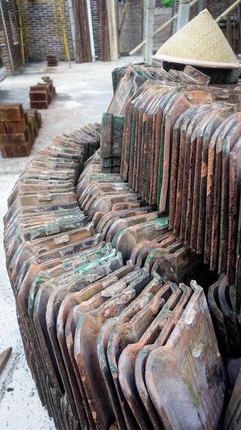 A large stack of tiles with green paint on the outside.