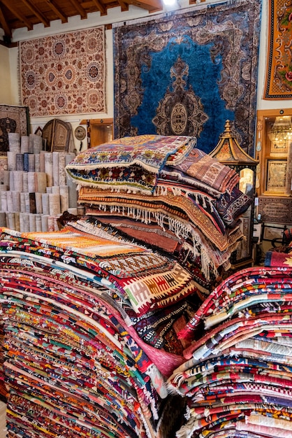 Large stacks of oriental rugs in a store colorful carpet market\
turkey