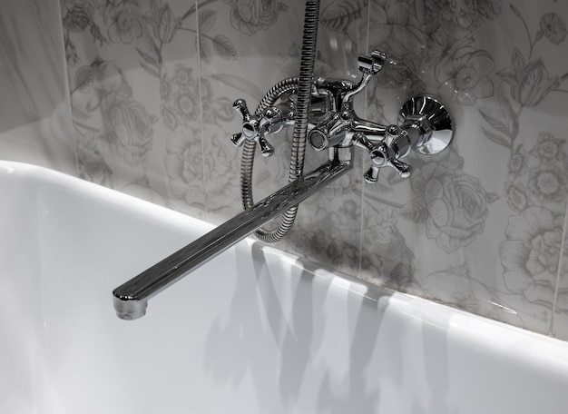 Photo large steel faucet mounted above bathtub decorative tiles wall in gray tones bathroom water tap