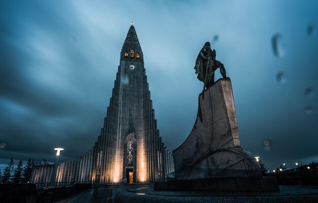 A large stone building with a statue in front of it that says'the temple of iceland '