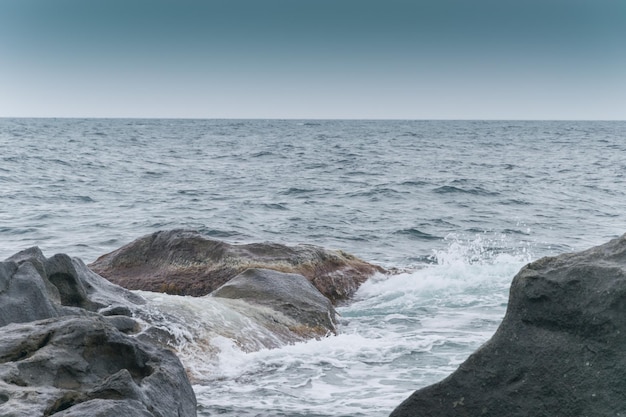 Large stones boulders on the seashore the ocean Overcast weather on vacation