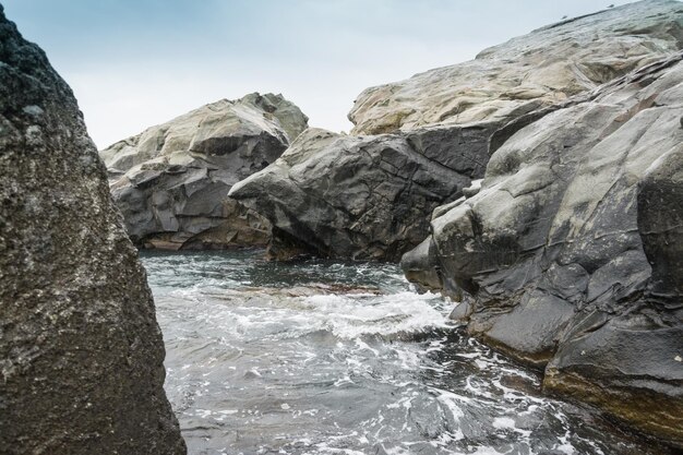 Large stones boulders on the seashore the ocean Overcast weather on vacation