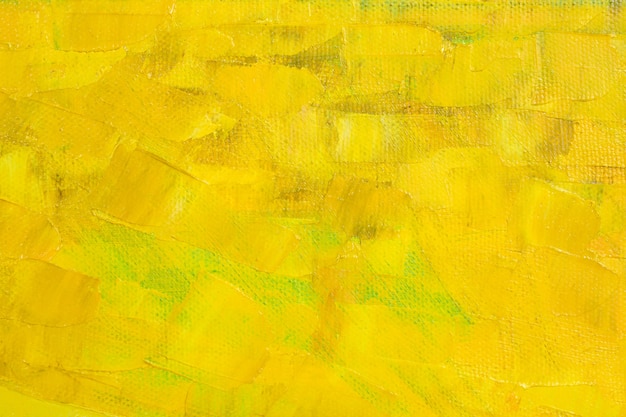 Large strokes of various shades of yellow oil paint on the surface of the canvas.