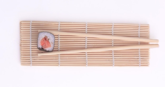 Large sushi and chopsticks isolated on a light