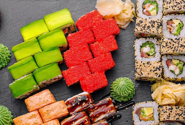 Large sushi set shot from the top on a black background