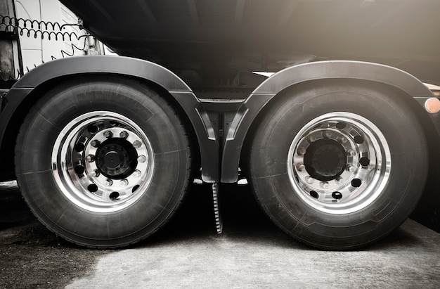 Photo large a truck wheels and tires of semi truck. freight transportation.