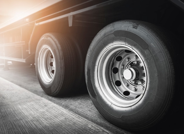 Photo large a truck wheels of trailer truck. freight transportation.