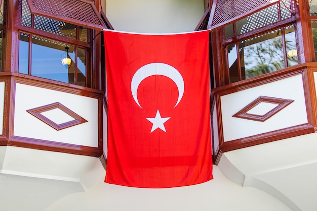 Large Turkish flag displayed prominently on the wall of a house representing national pride and identity