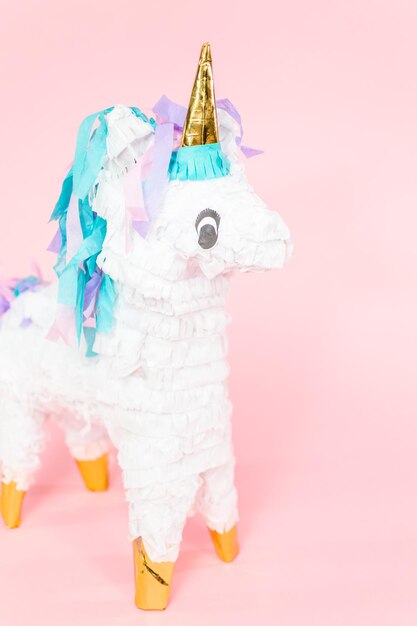 Photo large unicorn pinata on pink background.