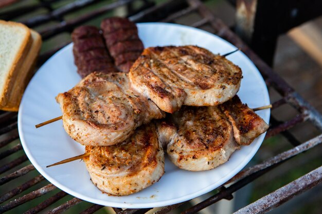 A large variety of grilled meat on the fire outside