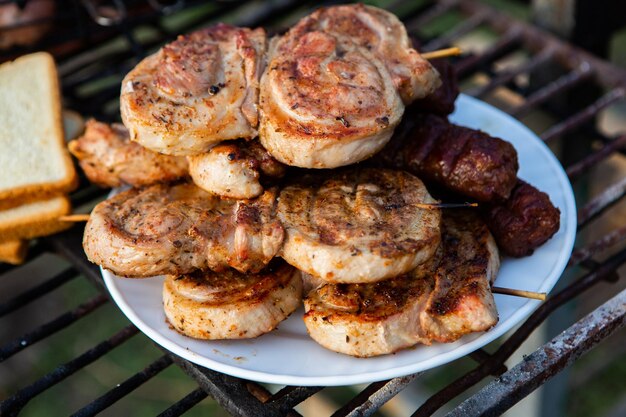 A large variety of grilled meat on the fire outside