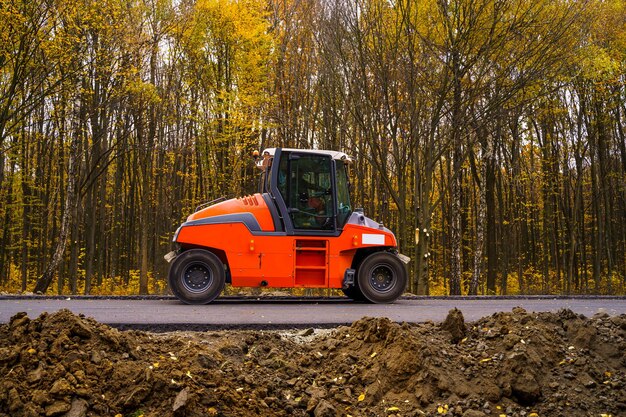 Large view on the road machinery working on the new road
construction site paving new asphalt on road